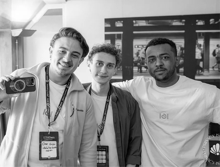 Three node101 team members at a conference